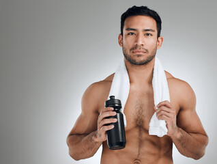 If you want it bad enough, youll sweat for it. Shot of an athletic man holding a bottle of water...