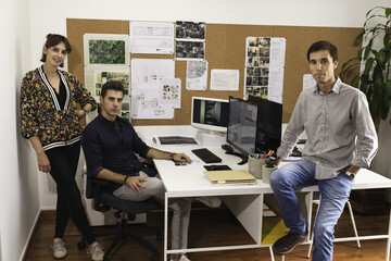 Closeup of young architects discussing together inside a conference room