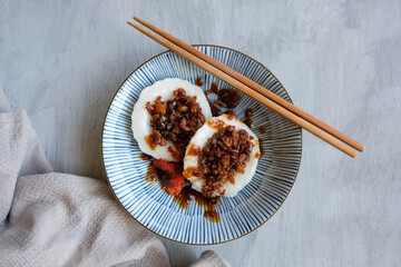 Homemade Chinese popular street food. Chwee Kueh aka Steamed Rice Cake with Preserved Turnip. Eaten with chili and soy paste sauce.