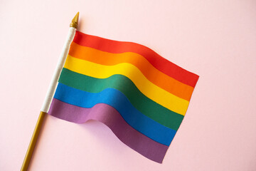 Rainbow LGBT flag on pink surface, concept picture about human rights and equality