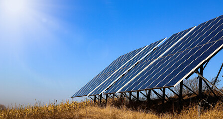 Photovoltaic batteries on a background of rich, bright blue sky. Solar panels. Alternative energy concept