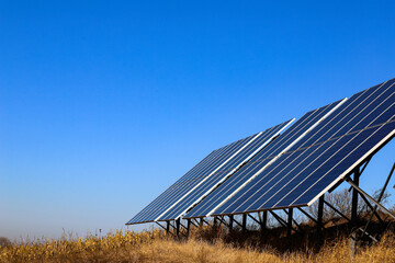 Photovoltaic batteries on a background of rich, bright blue sky. Solar panels. Alternative energy concept