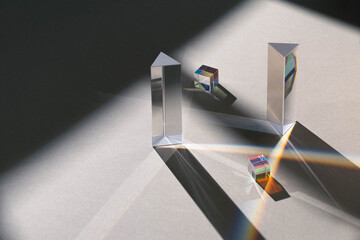dichroic glass cube, prism, with reflection rainbow light beams on neutral background and window...