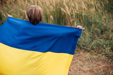 Ukraines Independence Flag Day. Constitution day. Ukrainian child boy in shirt with yellow and blue flag of Ukraine in field. flag symbols of Ukraine. Kyiv, Kiev day