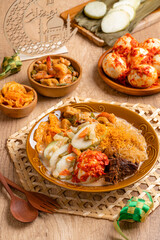 Lontong sayur or vegetable rice cake is an Indonesian traditional rice dish made of pieces of lontong served in coconut milk soup with shredded chayote, tempeh, tofu, hard-boiled egg, sambal, rendang