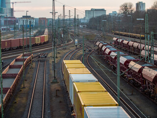 Fototapeta na wymiar Freight station, rails, trains with bulk wagons and container wagons near Frankfurt am Main. Transportation and logistics of various goods. 