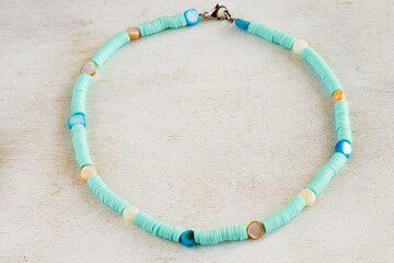 Beautiful necklace with stones and beads on a white surface.