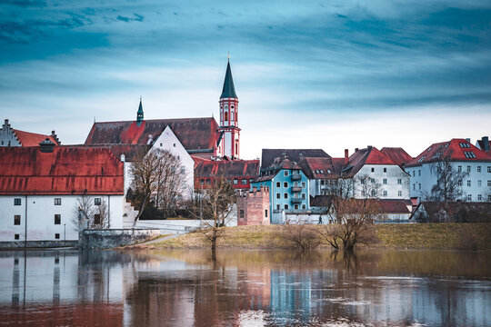 Beautiful shot of a Straubing cityscape and river Danube against a cloudy sky