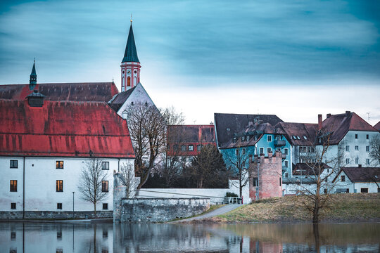 Beautiful shot of a Straubing cityscape and river Danube against a cloudy sky