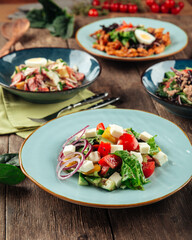 Side view on assorted greek tuna sausages and chicken salads