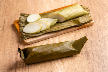 Lontong is an Indonesian dish. Rice is rolled inside a banana leaf and boiled, then cut into small cakes as a staple food replacement of steamed rice.