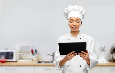 cooking, culinary and people concept - happy smiling female chef with tablet pc computer over...