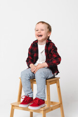 Portrait of a little smiling boy on white plain background - preschool kid