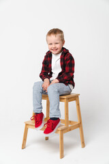 Portrait of a little smiling boy on white plain background - preschool kid
