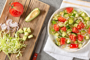 Salad of fresh vegetables and herbs with quinoa seeds and olive oil