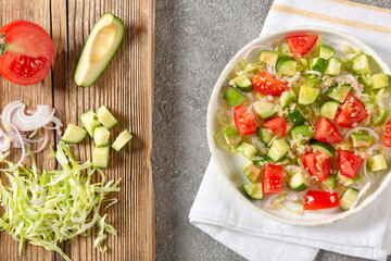 Salad of fresh vegetables and herbs with quinoa seeds and olive oil
