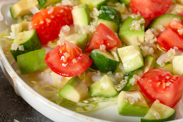 Salad of fresh vegetables and herbs with quinoa seeds and olive oil