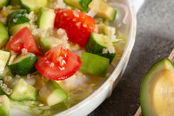 Salad of fresh vegetables and herbs with quinoa seeds and olive oil
