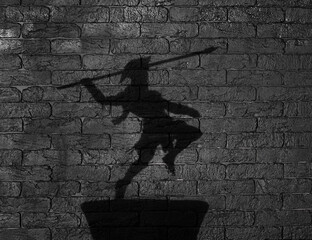 shadow of a spartan on a black background