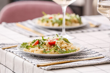 Plate of delicious pasta with arugula on table, closeup