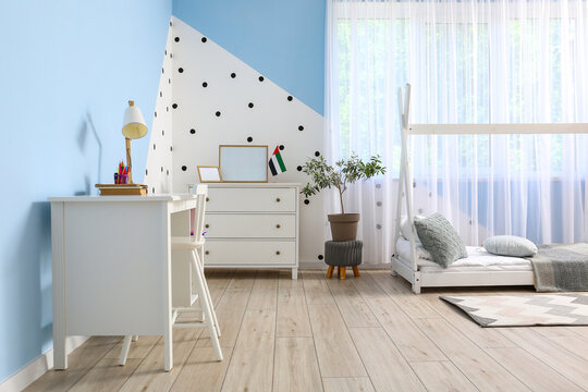 Interior Of Stylish Children's Bedroom With Desk And UAE Flag