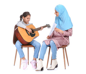 Private Muslim music teacher giving guitar lesson to little girl on white background