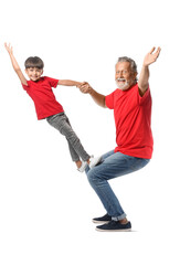 Little boy and his grandfather in red t-shirts on white background