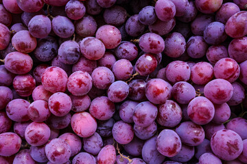 Close up of raw organic sweet red grapes background.