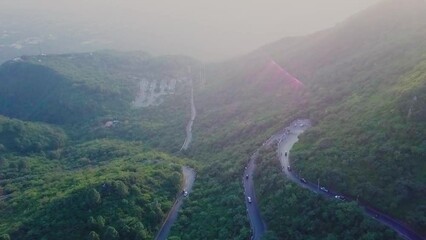 Aerial Over Winding Roads Near Daman E Koh In Margalla Hills. Dolly Forward Tilt Down