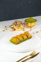 Pistachio baklava on white marble. Traditional middle eastern dessert. Turkish Antep baklava.