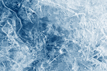 Obraz na płótnie Canvas Ice background texture. Frozen water in various geometric abstract shapes. Seasonal natural effect. Cold weather. The surface of the winter water reservoir.