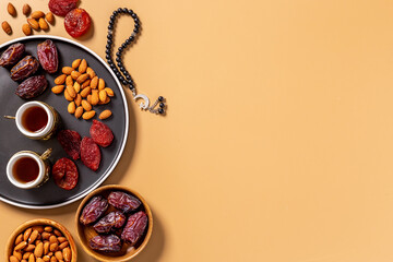 Ramadan Kareem background. Islamic rosary and dates fruits with tea