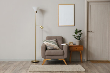 Interior of modern room with standing lamp, armchair and table