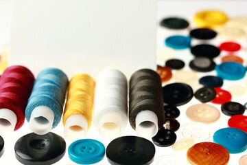 Multicolored threads and buttons for clothes.