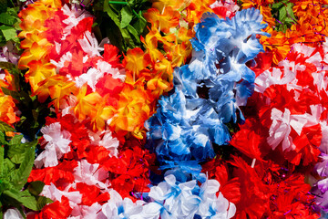 heap of artificial flowers, made from differnt colors textile.