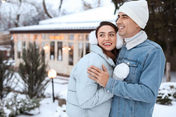 Pair of sweethearts on snowy winter day