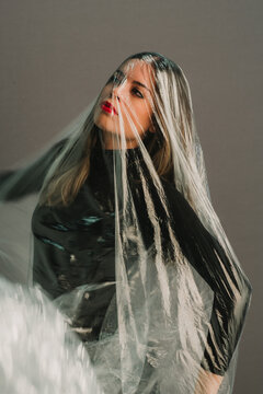 Woman under transparent plastic wrap