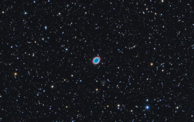 The Ring Nebula, Messier 57 is a planetary emission nebula in the constellation of Lyra. Night sky...