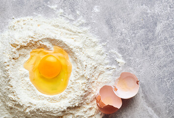 Baking ingredients. Flat lay composition with ingredients for making dough. Flour and eggs on rustic table background with copy space
