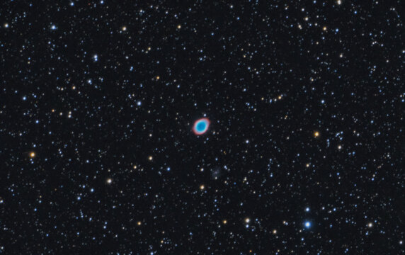 The Ring Nebula, Messier 57 is a planetary emission nebula in the constellation of Lyra. Night sky stars background