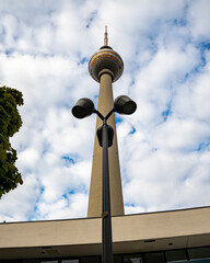 Low angle shot of Berlin Fernsehturm against blue cloudy sky in Alexanderplatz, Berlin, Germany