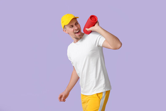 Emotional Man With Wireless Portable Speaker On Violet Background