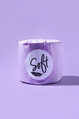 Toilet paper roll on purple background
