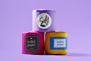 Stack of toilet paper rolls on purple background