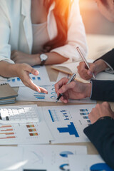 Group of business people working on graph chart, talking, planning analyze investment and marketing...