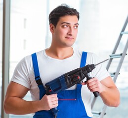 Young worker with hand drill