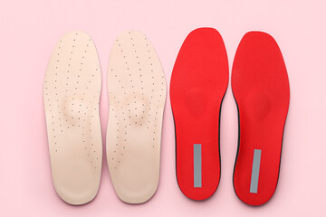 Orthopedic insoles on pink background