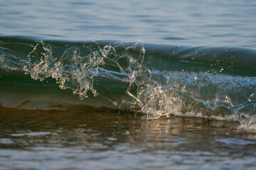Waves about to break at sunset and low tide
