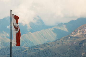 flag of tirol in the mountain landscape - obrazy, fototapety, plakaty