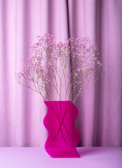 Dried flowers bouquet in pink vase on purple, violet background. Interior decor idea. High quality photo